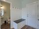 Entryway features a bench, coat hooks and access to a half bath, blending functionality with style at 3018 Vincent Astor Dr, Johns Island, SC 29455