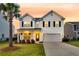 Charming two-story home with manicured lawn, attached garage and beautiful landscaping at 3018 Vincent Astor Dr, Johns Island, SC 29455