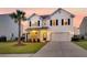 Charming two-story home with a well manicured yard, a palm tree and two car garage at 3018 Vincent Astor Dr, Johns Island, SC 29455