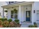 Charming front porch with hanging plants, a blue door, and manicured landscaping at 3018 Vincent Astor Dr, Johns Island, SC 29455