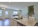 Open kitchen view with granite island, stainless sink, and view to living room and staircase at 3018 Vincent Astor Dr, Johns Island, SC 29455