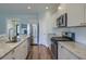 Well-equipped kitchen features stainless appliances, granite countertops, tile backsplash and wood floors at 3018 Vincent Astor Dr, Johns Island, SC 29455