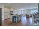 Open-concept living space with kitchen island, modern appliances, and hardwood floors at 3018 Vincent Astor Dr, Johns Island, SC 29455