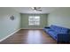 Spacious living room with a blue sofa, ceiling fan, and ample natural light at 3018 Vincent Astor Dr, Johns Island, SC 29455