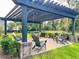 Inviting outdoor lounge area with pergola, string lights, and comfortable seating for relaxing or entertaining at 3018 Vincent Astor Dr, Johns Island, SC 29455