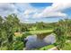 Picturesque view of a pond surrounded by lush landscaping and mature trees in a peaceful setting at 3018 Vincent Astor Dr, Johns Island, SC 29455