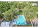 Aerial view of community pool and amenity building with manicured lawns and a meandering walking trail at 3018 Vincent Astor Dr, Johns Island, SC 29455