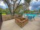 Community pool with seating area, fire pit, and lush landscaping with mature trees offering shade from the sun at 3018 Vincent Astor Dr, Johns Island, SC 29455