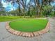 Artificial turf putting green area with brick border and gravel surround perfect for practicing your short game at 3018 Vincent Astor Dr, Johns Island, SC 29455