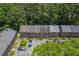 Brick townhomes from above, surrounded by lush trees and showcasing the parking and roofs at 302 Springview Ln # 7, Summerville, SC 29485