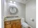 Half bathroom with granite countertop, decorative mirror, and wood grain vanity at 302 Springview Ln # 7, Summerville, SC 29485