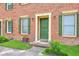 Close-up of brick townhouse featuring a green front door and decorative shutters at 302 Springview Ln # 7, Summerville, SC 29485