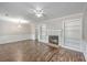 Cozy living room featuring a fireplace, built-in shelves, and hardwood floors at 302 Springview Ln # 7, Summerville, SC 29485