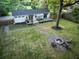 Inviting backyard with a fire pit, wooden deck, and gravel pathways, perfect for outdoor enjoyment at 3435 Hobson Dr, Johns Island, SC 29455