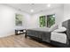 Bright bedroom with a slider to the outside features neutral colors, hardwood floors and a comfortable bed at 3435 Hobson Dr, Johns Island, SC 29455
