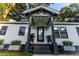 Charming home with a inviting front porch, dark trim, and updated landscaping at 3435 Hobson Dr, Johns Island, SC 29455
