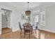 Elegant dining area with hardwood floors, modern lighting, and access to the outdoor area at 3513 Flowering Oak Way, Mount Pleasant, SC 29466