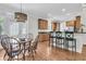 Bright dining area featuring a modern light fixture and adjacent kitchen with stainless appliances at 3513 Flowering Oak Way, Mount Pleasant, SC 29466
