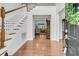 Elegant foyer with gleaming hardwood floors and staircase, leading to a bright and open living space at 3513 Flowering Oak Way, Mount Pleasant, SC 29466