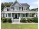 Charming two-story home with a welcoming front porch, beautiful blue siding, and well-maintained landscaping at 3513 Flowering Oak Way, Mount Pleasant, SC 29466