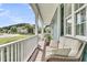Inviting front porch with comfortable wicker furniture, offering a relaxing outdoor space with neighborhood views at 3513 Flowering Oak Way, Mount Pleasant, SC 29466