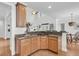 Open-concept kitchen featuring granite countertops, stainless appliances, and bar seating at 3513 Flowering Oak Way, Mount Pleasant, SC 29466