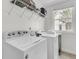 Bright laundry room with modern washer and dryer, shelving and window at 3513 Flowering Oak Way, Mount Pleasant, SC 29466