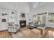 Bright and airy living room boasting a fireplace, built-in shelving, and large windows for natural light at 3513 Flowering Oak Way, Mount Pleasant, SC 29466