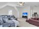 Upstairs living room featuring neutral carpeting and a large TV at 3513 Flowering Oak Way, Mount Pleasant, SC 29466