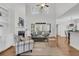 Bright living room featuring high ceilings, large windows, a cozy fireplace, and stylish decor at 3513 Flowering Oak Way, Mount Pleasant, SC 29466