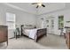 Spacious main bedroom with a tray ceiling, a ceiling fan, and access to the outside through French doors at 3513 Flowering Oak Way, Mount Pleasant, SC 29466