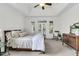 Spacious main bedroom with a tray ceiling, a ceiling fan, and access to the outside through French doors at 3513 Flowering Oak Way, Mount Pleasant, SC 29466