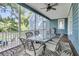 Relaxing outdoor porch with dining set, comfortable seating, decorative rug, ceiling fan, and a grill at 3513 Flowering Oak Way, Mount Pleasant, SC 29466