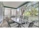 Relaxing outdoor porch with dining set, comfortable seating, decorative rug, and a beautiful natural view at 3513 Flowering Oak Way, Mount Pleasant, SC 29466