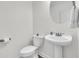 Well-lit powder room featuring pedestal sink, toilet, and contemporary fixtures at 3513 Flowering Oak Way, Mount Pleasant, SC 29466