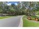 Elegant community entrance with brick signage, mature trees and colorful landscaping at 3524 Great Egret Dr, Johns Island, SC 29455