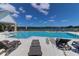 Sparkling community pool with lounge chairs, surrounded by lush landscaping and tranquil lake views at 3524 Great Egret Dr, Johns Island, SC 29455