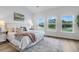 Bright main bedroom boasts a beautiful water view from large windows and wood-look flooring at 3524 Great Egret Dr, Johns Island, SC 29455