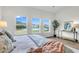 Bright main bedroom features wood-look floors, serene water views and modern decor at 3524 Great Egret Dr, Johns Island, SC 29455