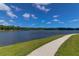 Picturesque community walking path alongside a serene pond, perfect for exercise and enjoying nature at 3524 Great Egret Dr, Johns Island, SC 29455