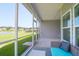Covered outdoor seating area with a view of the tranquil pond and well-kept lawn at 3524 Great Egret Dr, Johns Island, SC 29455