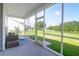 Relaxing screened-in porch overlooking a serene lake and green lawn at 3524 Great Egret Dr, Johns Island, SC 29455