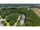 Aerial view of neighborhood surrounded by lush trees and open fields at 3574 Toomer Kiln Cir, Mount Pleasant, SC 29466