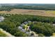 Aerial view of homes surrounded by lush trees and a open field at 3574 Toomer Kiln Cir, Mount Pleasant, SC 29466