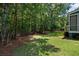 View of a private backyard featuring lush greenery, a wooden fence, and mature trees at 3574 Toomer Kiln Cir, Mount Pleasant, SC 29466