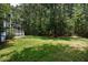 Expansive backyard features lush lawn and mature trees, creating a private and serene outdoor oasis at 3574 Toomer Kiln Cir, Mount Pleasant, SC 29466