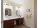 Dual sink bathroom vanity with dark wood cabinets and ample counter space in a well-lit area at 3574 Toomer Kiln Cir, Mount Pleasant, SC 29466