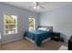 Bright bedroom features a ceiling fan, two windows letting in lots of natural light and a comfortable bed at 3574 Toomer Kiln Cir, Mount Pleasant, SC 29466