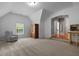 Large bonus room with armoire, chair, and archway provides an adaptable space for homeowners at 3574 Toomer Kiln Cir, Mount Pleasant, SC 29466