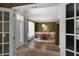 Stylish dining room with hardwood floors, elegant lighting, and a large window providing ample natural light at 3574 Toomer Kiln Cir, Mount Pleasant, SC 29466